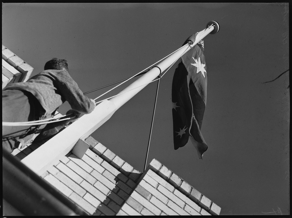 Legacy-Park-13-June-1939-man-raises-flag | RSL LifeCare - provide care and service to war veterans, retirement villages and accommodation, aged care services and assisted living